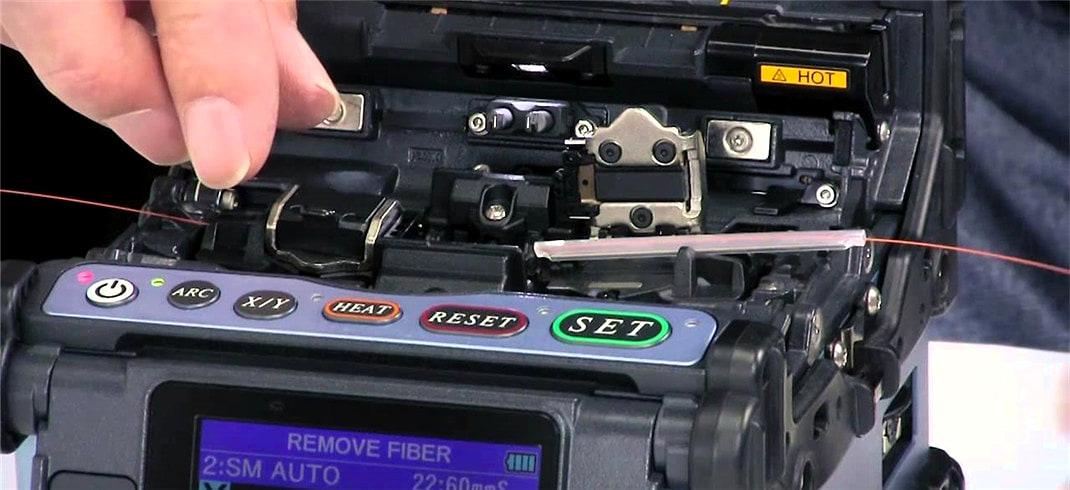Optical fibre being placed into a fusion splicer